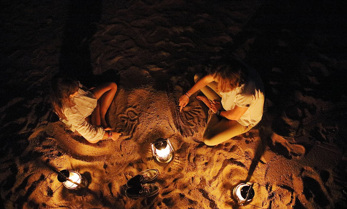 Children around a bon fire at londolozi